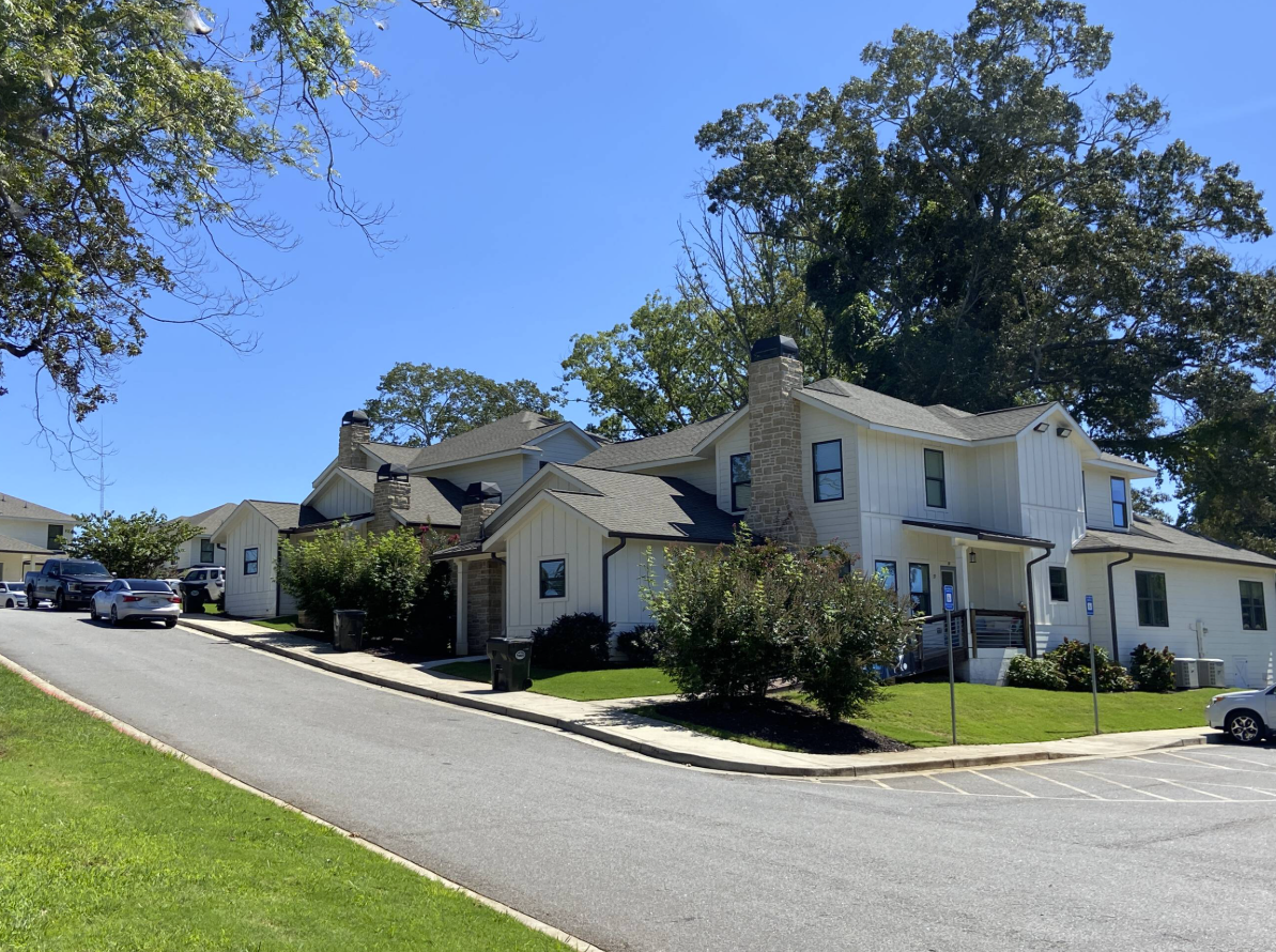 The Laurel, a white farmhouse-style student housing community in Dahlonega, Georgia.